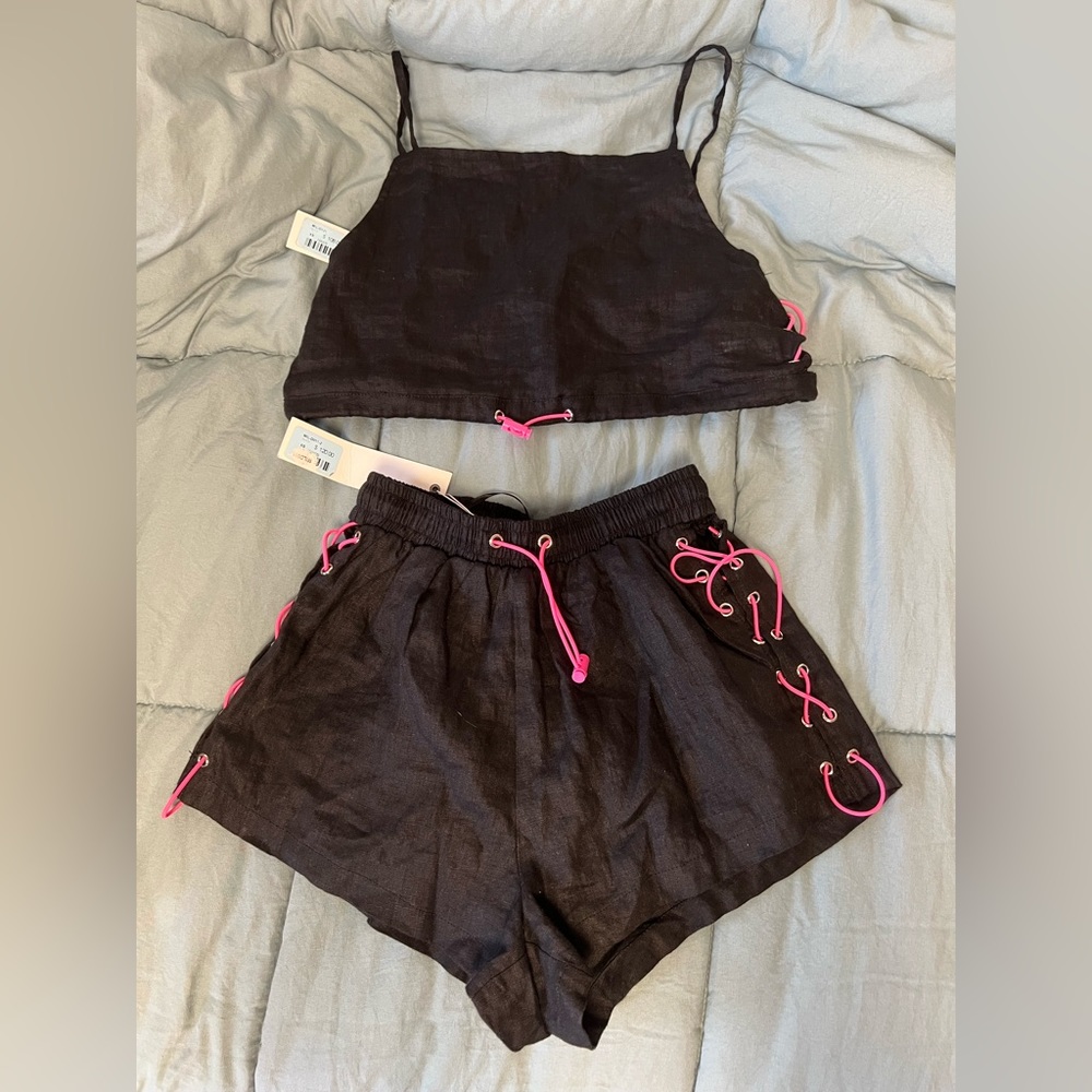 Millau two piece set; black crop top and shorts, both with pink adjustable lace